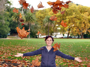 Maria playing with autumn leaves